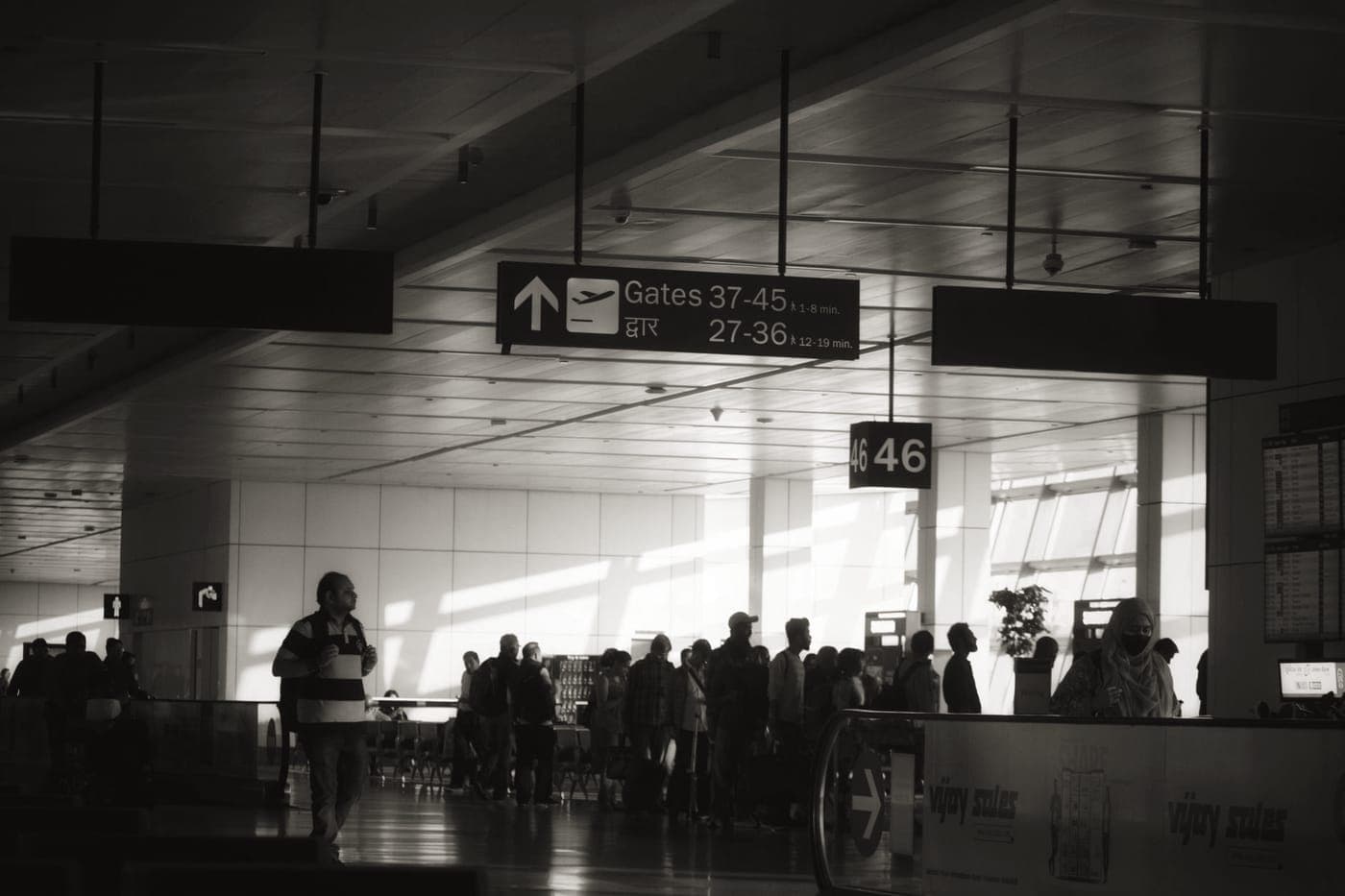 Passengers with cabin bags queuing at an airport boarding gate