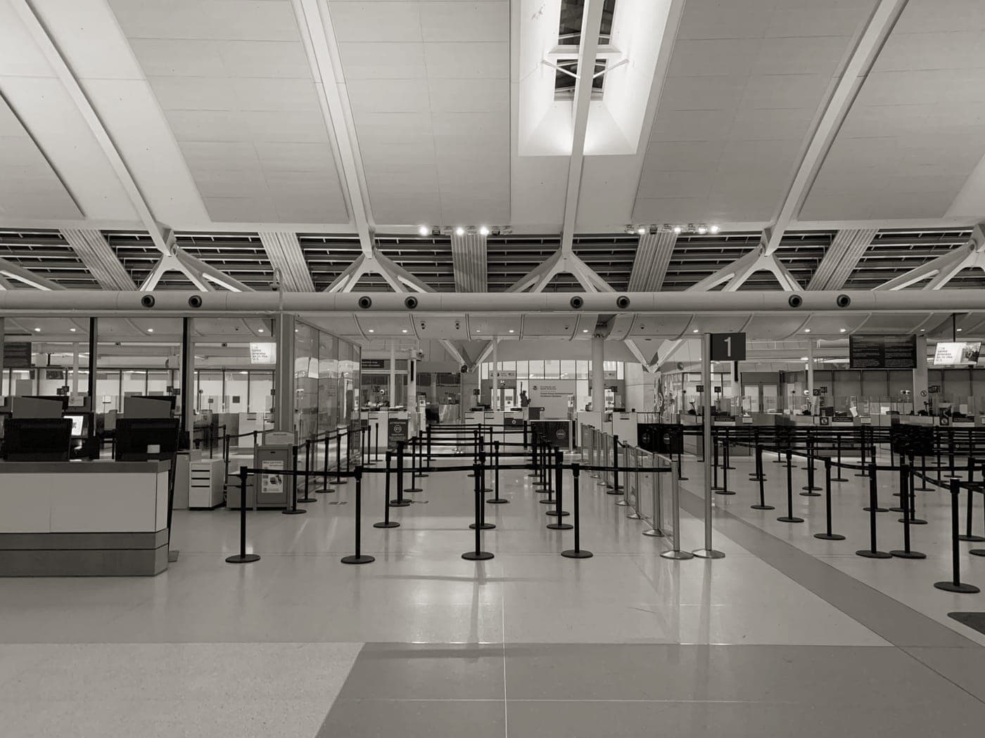 A gate agent area with passengers and cabin bags before boarding