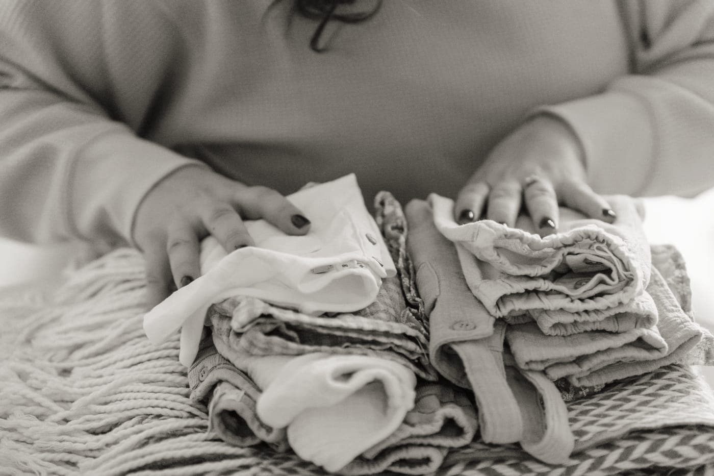 Folded clothes arranged in fabric packing cubes inside a suitcase